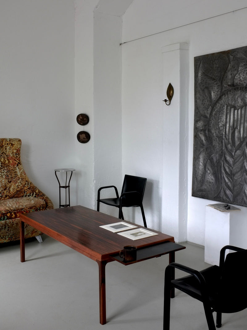 Vintage iron pedestal side table in minimalist living room setting