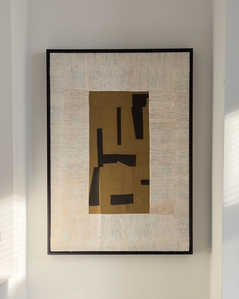 Abstract geometric painting with golden angular forms on textured beige background