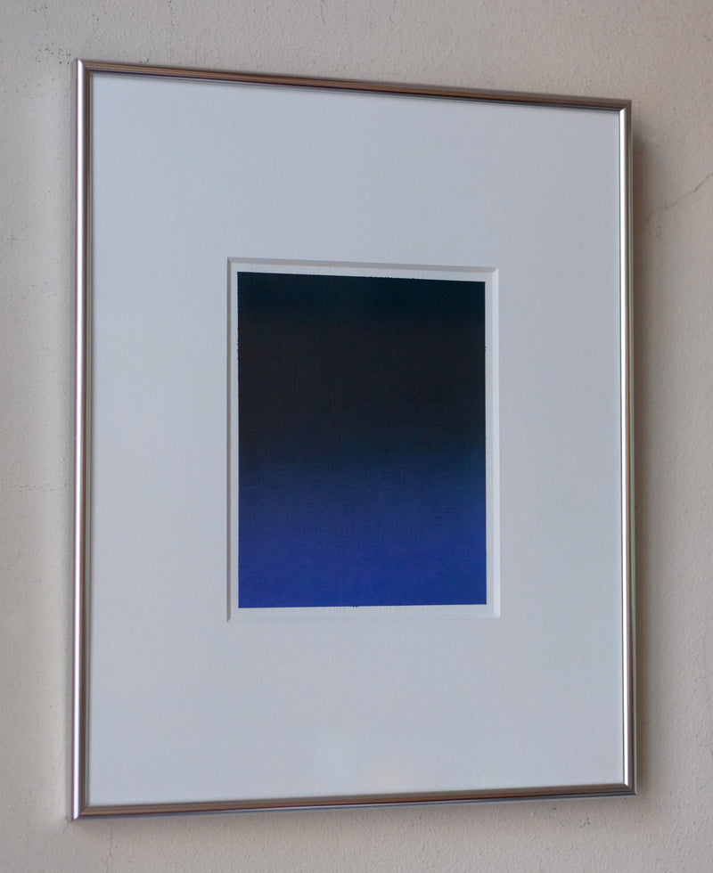 A framed art print titled "Untitled, 2024" by Rebecca von Matérn features a small rectangular piece with a gradient transitioning from dark to light blue, set against a white mat and an elegant silver frame, hanging on a light-colored wall.