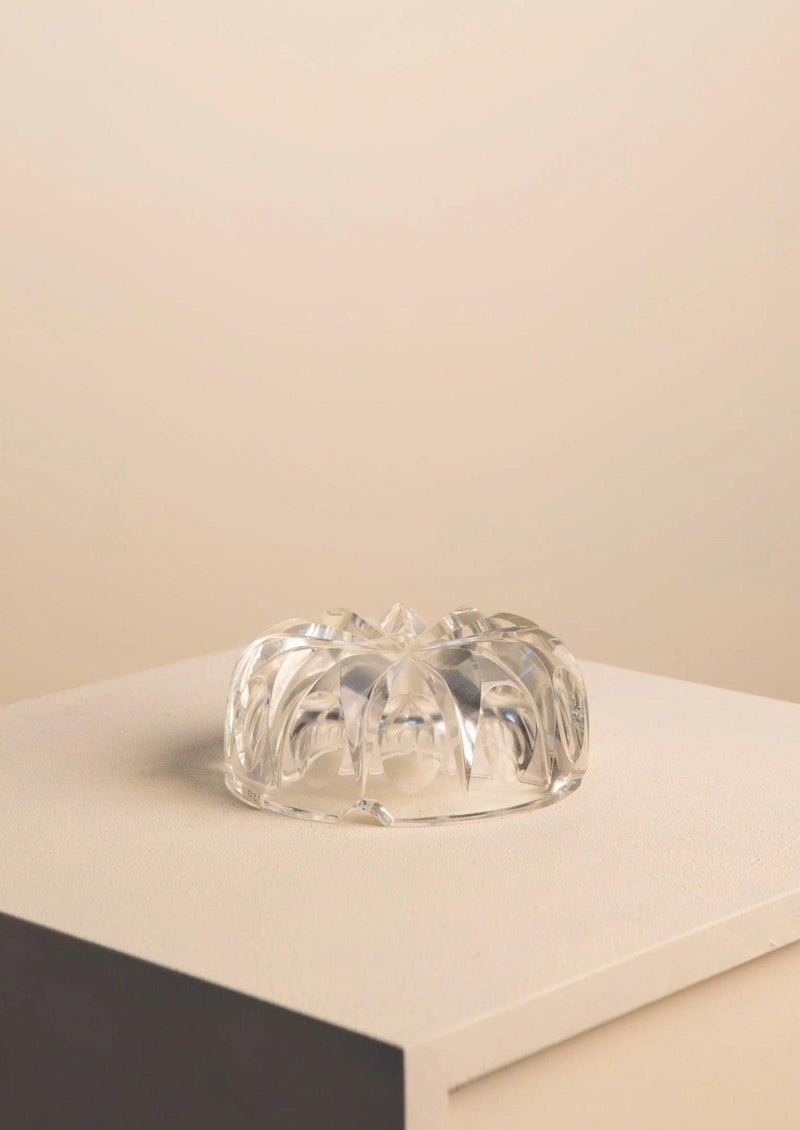An Italian glass artistry Murano Bowl by Flavio Poli for Seguso on a beige surface with a neutral-colored background, showcasing intricate designs and reflecting light.