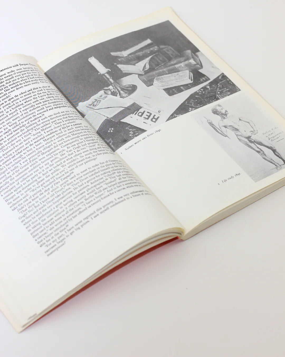 The Matisse on Art Book from Boga Avante Shop lies open on a white surface, displaying black and white text on the left. The right page features a collage with images of a nude statue, candle, and paper objects, capturing modern art's bold vision.