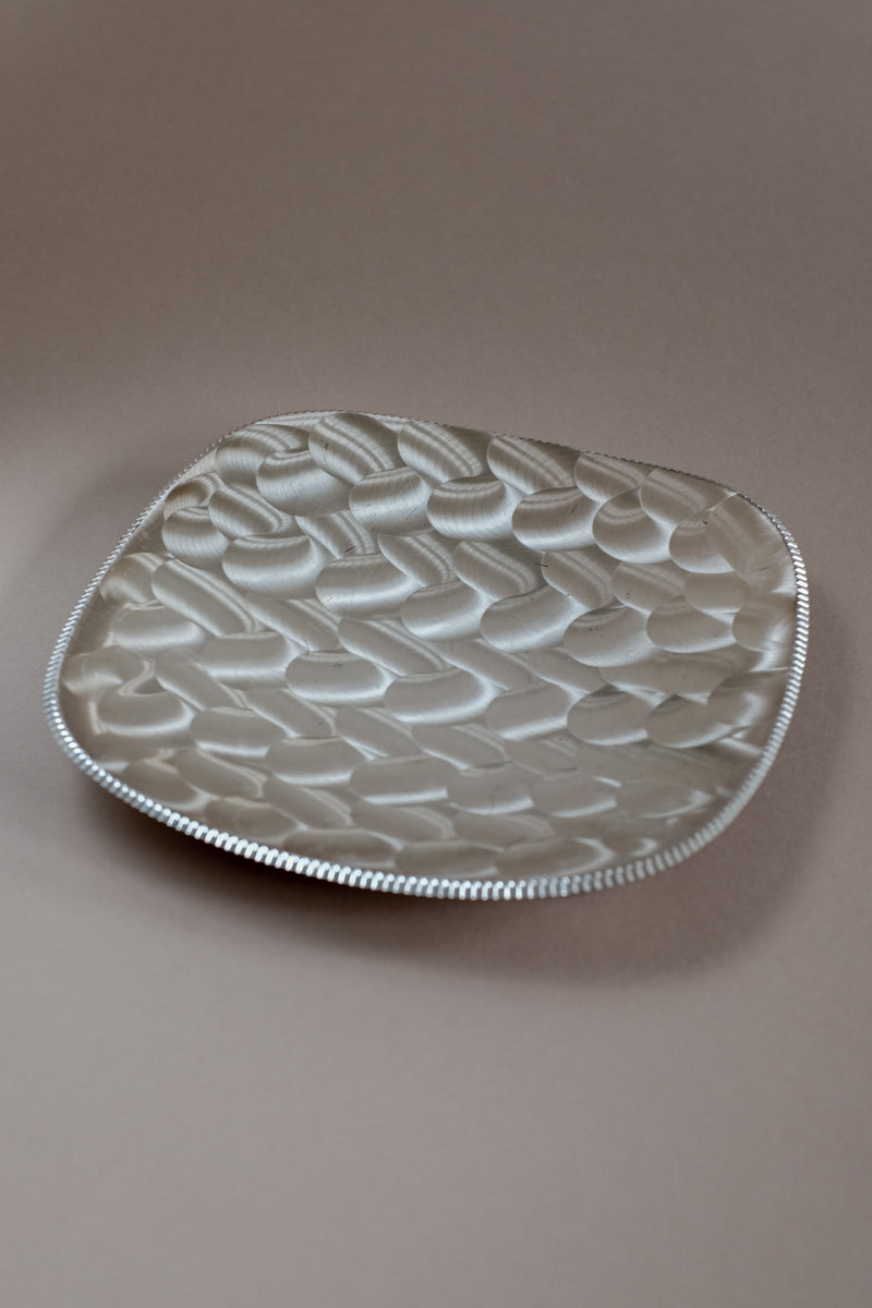 Silver-plated dish with textured honeycomb pattern surface detail