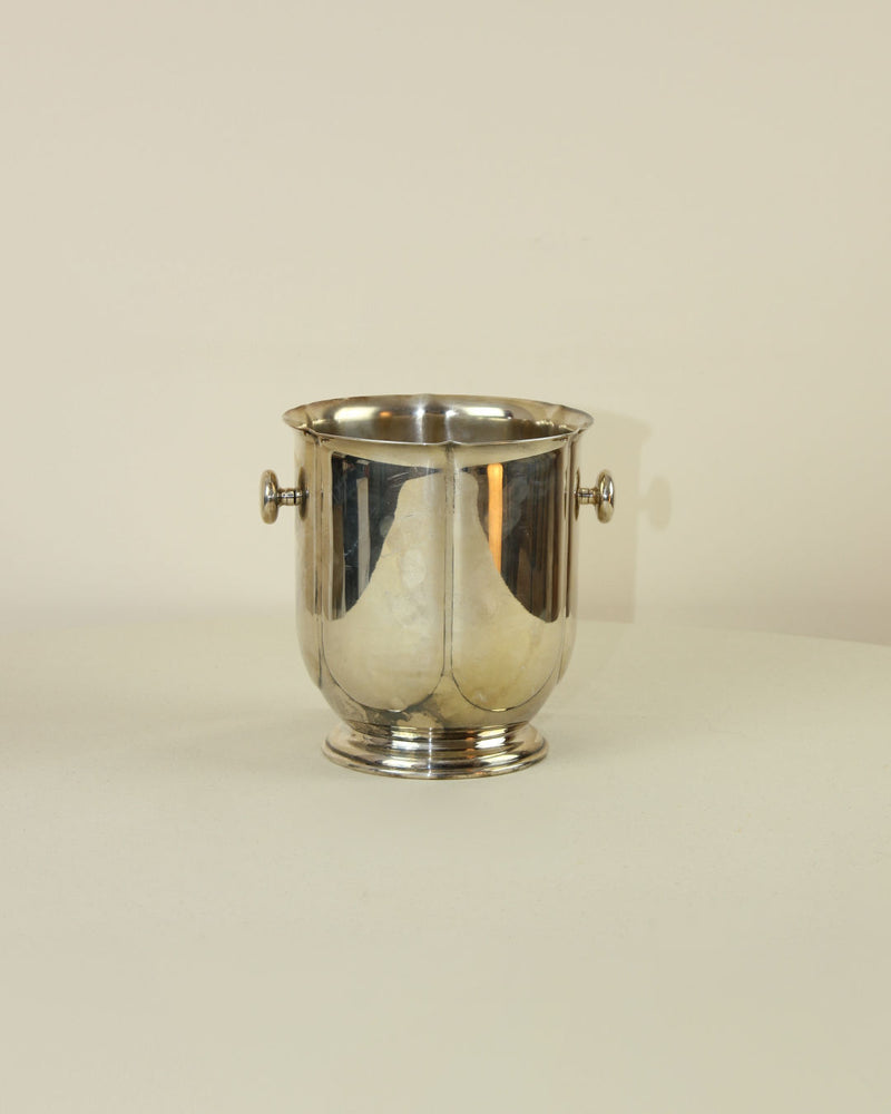 Italian silver-plated ice bucket with handles on beige background