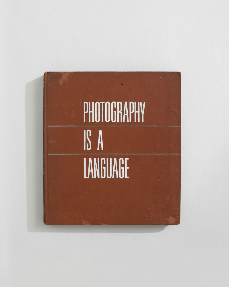 Photography is a Language hardcover book with brown cover