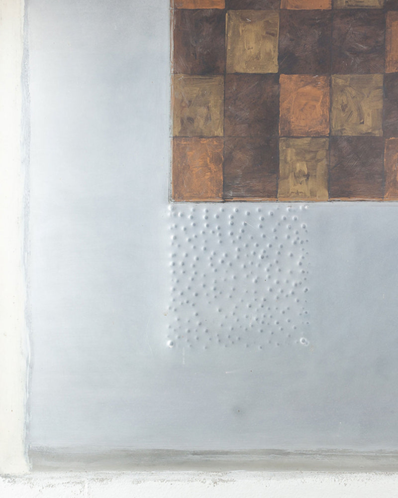 Mixed media artwork detail showing textured metal surface with painted squares and embossed dots