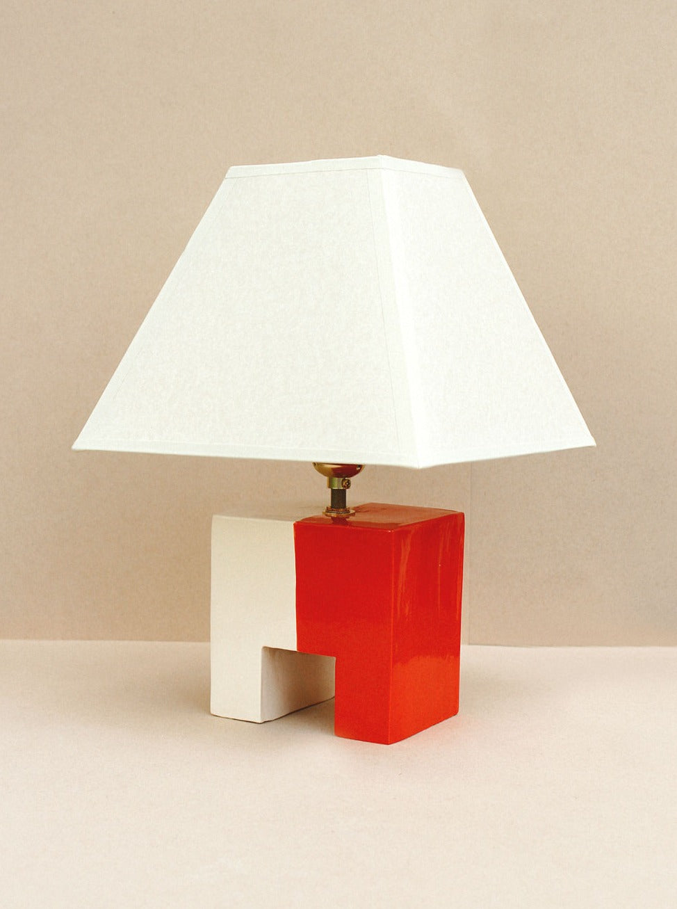 Handcrafted Cristo Lamp in vibrant red and bone color, perfect for modern home decor