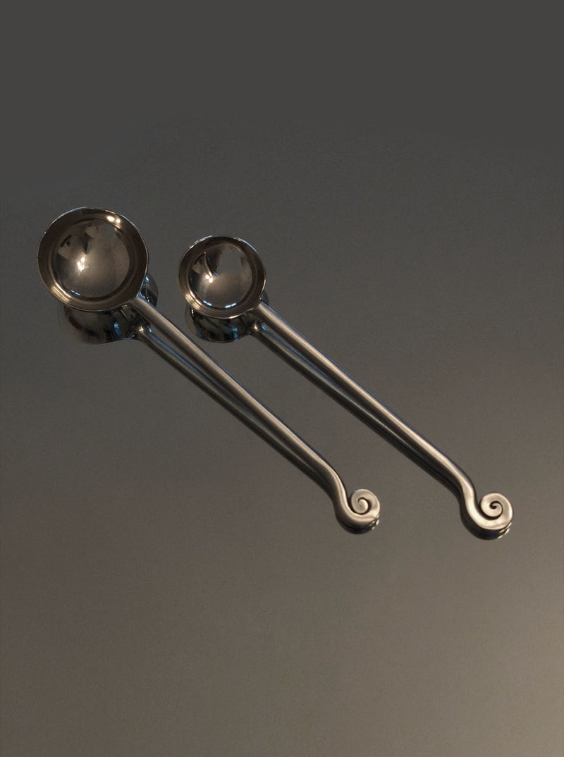Polished steel serving spoons with elegant spiral handle detail