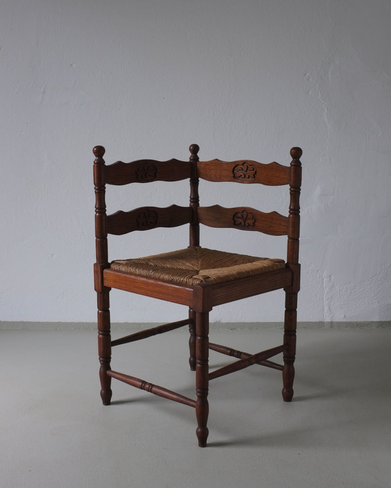 1950s carved oak corner chair with woven rush seat