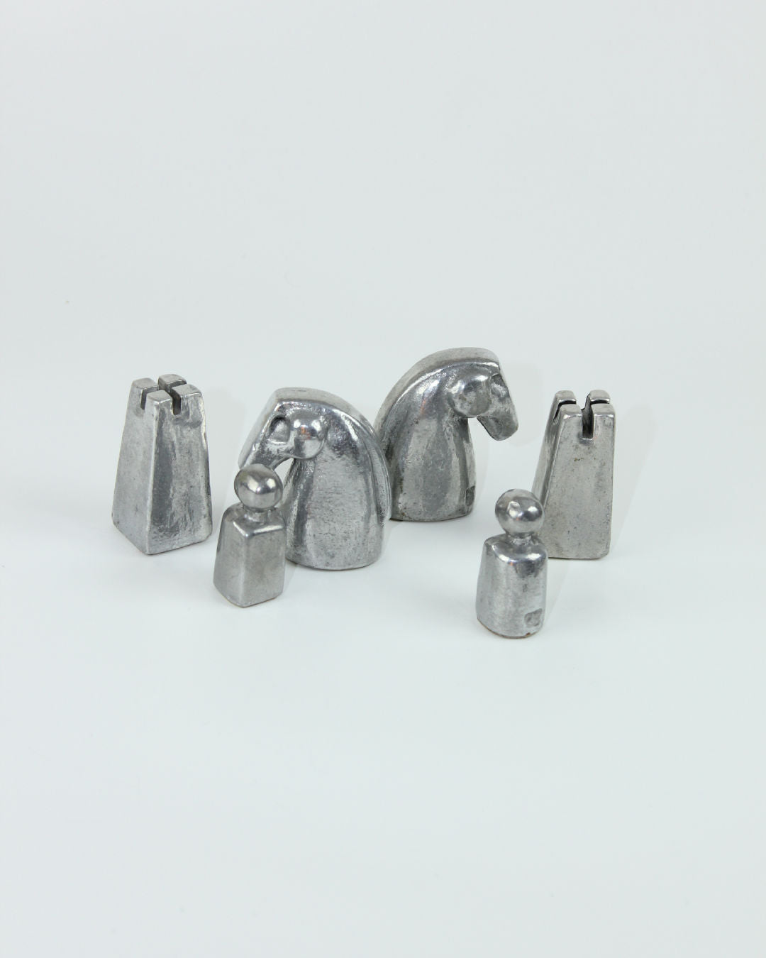 Brutalist chess pieces detail showing metallic finish and sculptural forms
