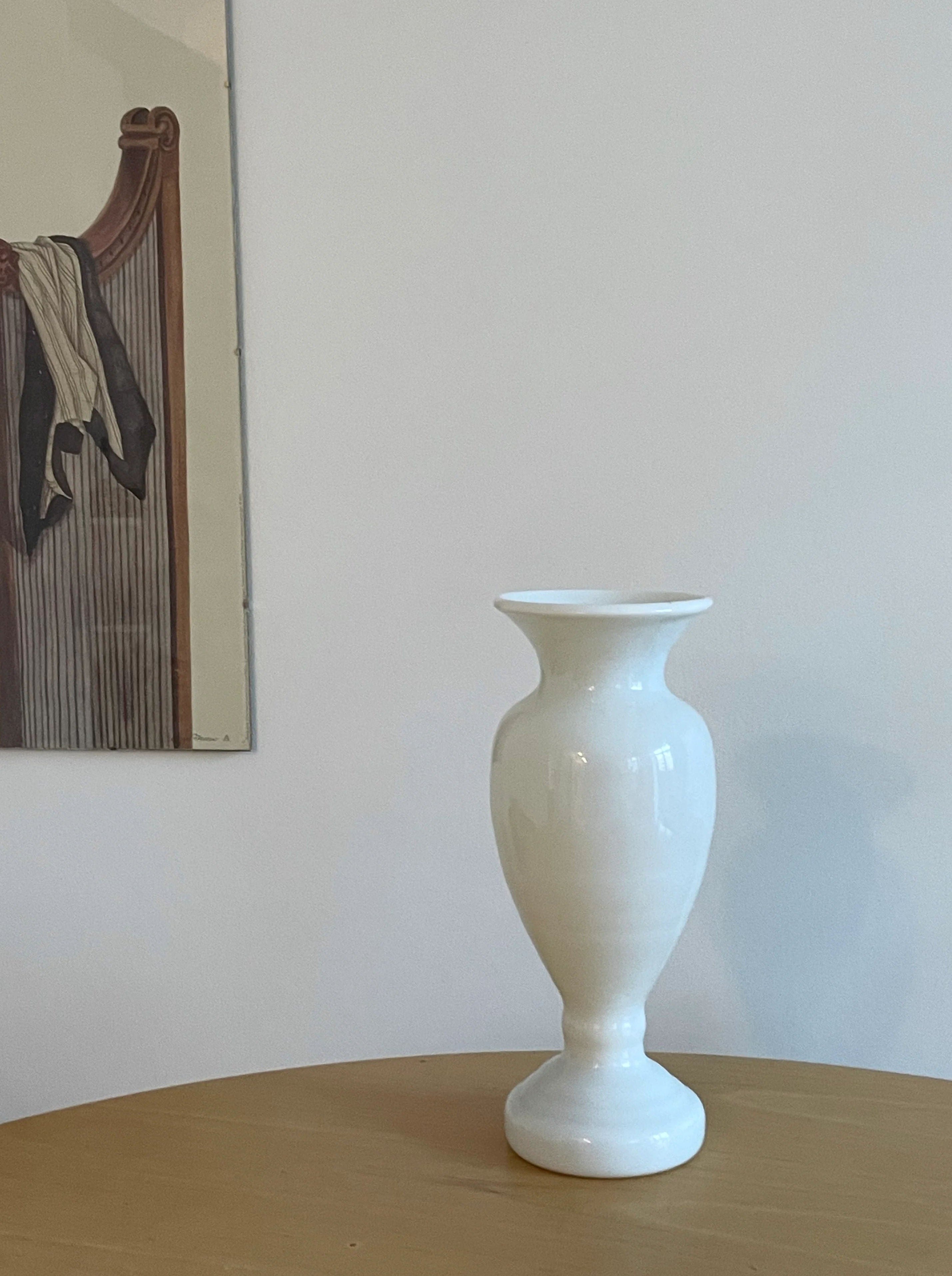 Tall and sleek white glass vase with a modern design