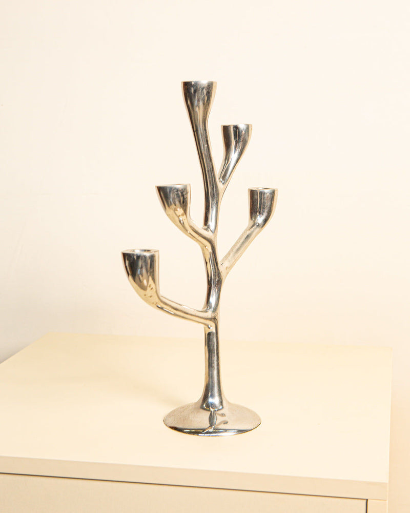 The Candleholder "Arbre" Aluminum 80's by Treaptyque boasts exquisite Italian craftsmanship in a sleek tree shape with four branches, elegantly displayed on a light table against a neutral background, highlighting its cast aluminum design.