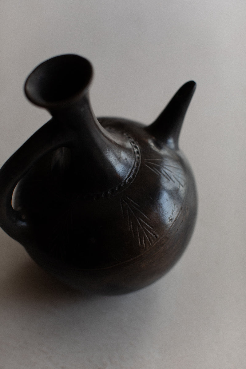 Traditional Ethiopian Teapot with a curved spout and decorative handle