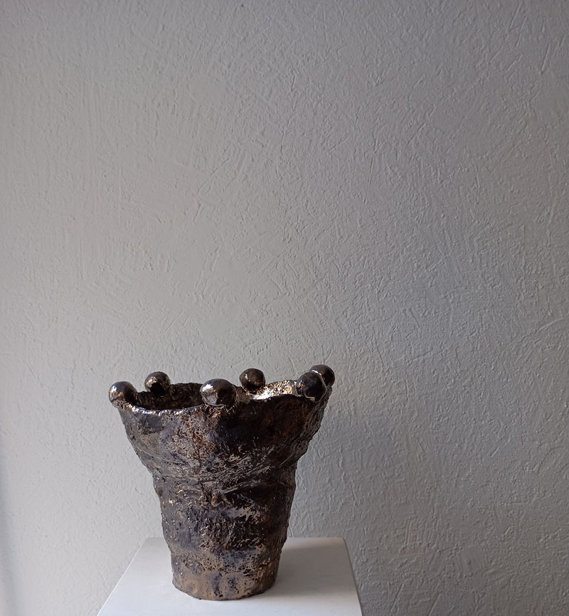 Handcrafted ceramic vessel with sculptural spherical rim details