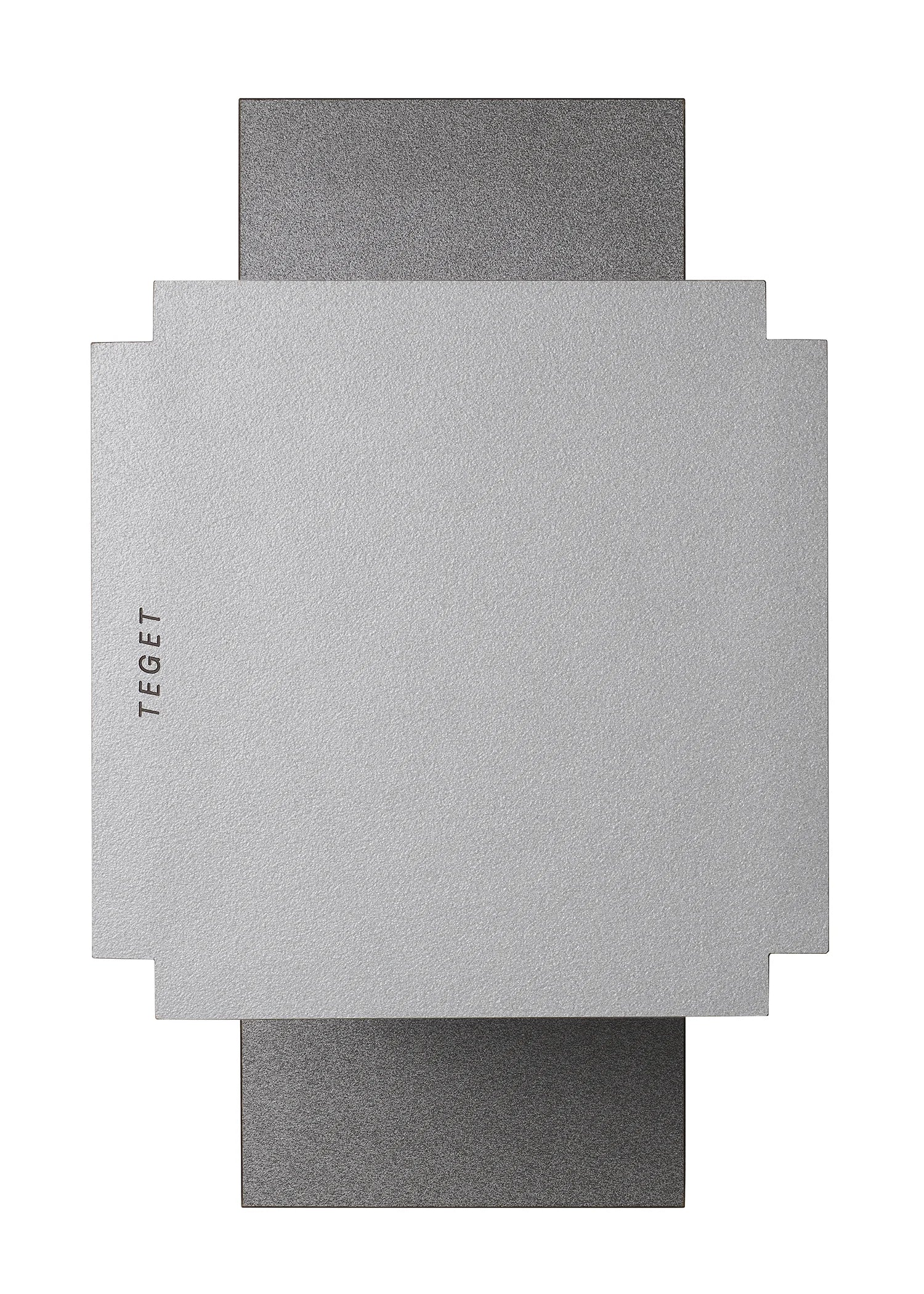 Wall-mounted lamp with a minimalist design featuring a large, square silver panel in front of a slightly smaller textured gray panel, creating a layered look. The word "TEGET" is printed on the left side of the silver panel. Perfect for complementing the "Mara T" Side Table – Silver Noise or any sleek laminated furniture.