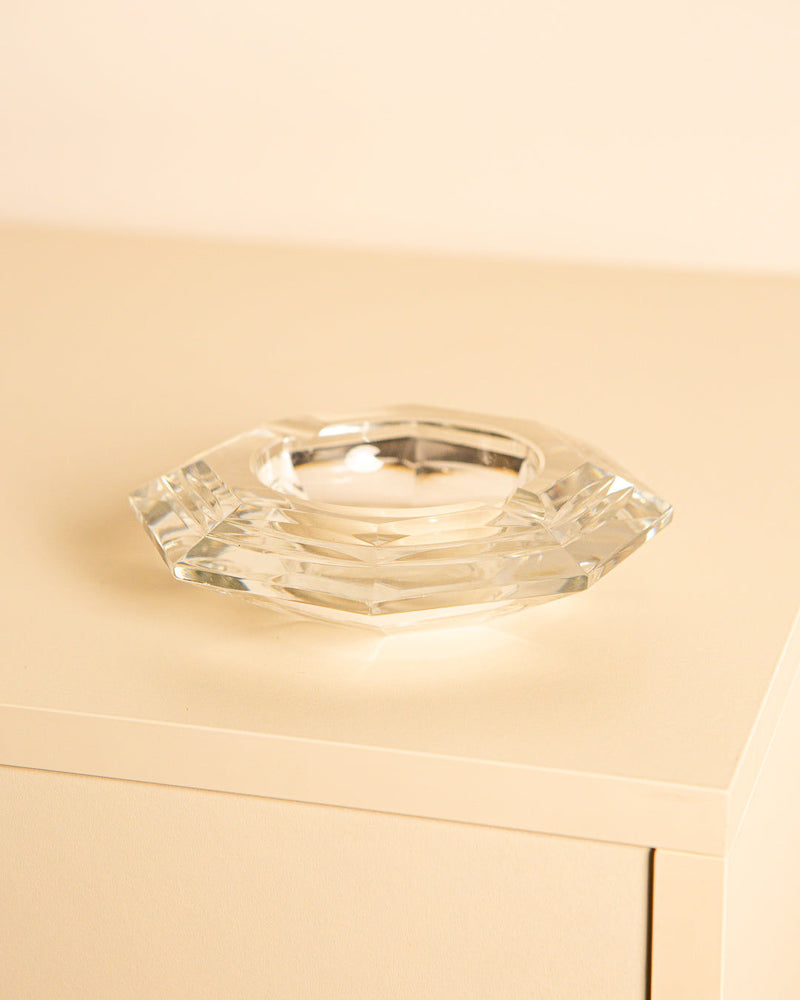 Clear crystal octagonal ashtray from 1960s Italy on beige surface