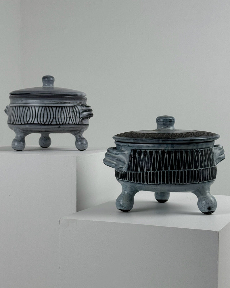 Two ceramic tureens with lids by Jacques Pouchain on white pedestals