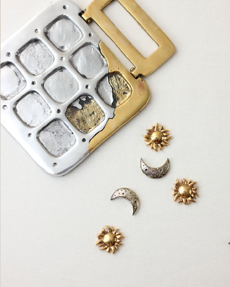 Brutalist tic tac toe game with gold brass frame and metal pieces
