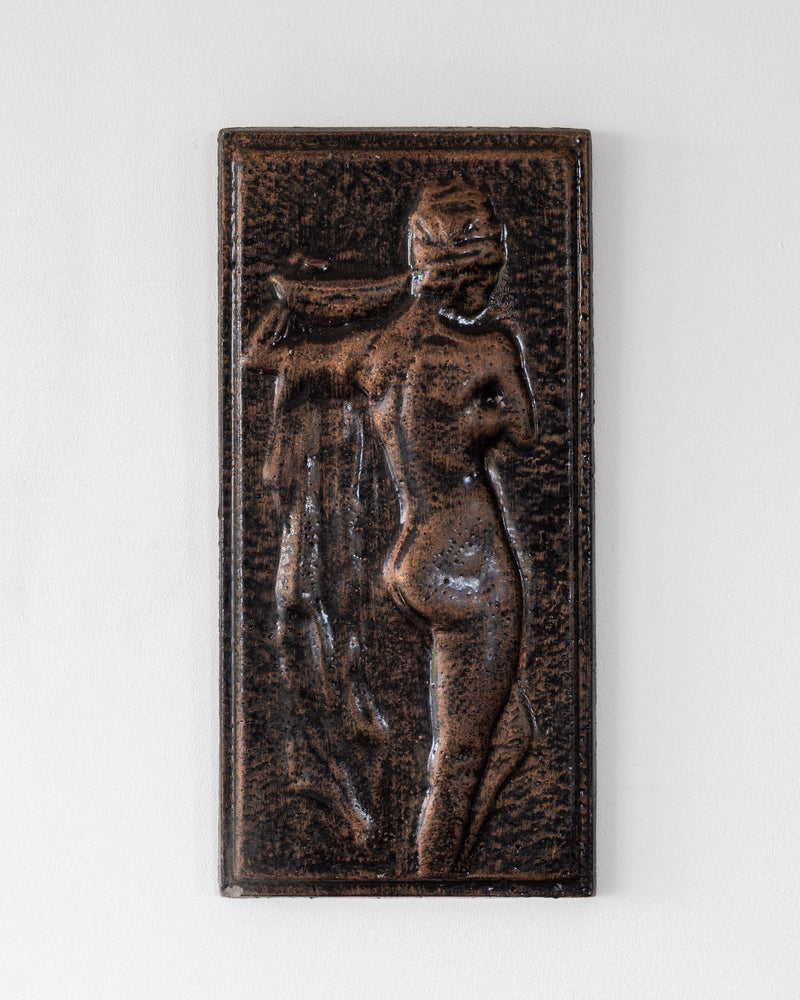 Vintage ceramic relief sculpture depicting standing female figure