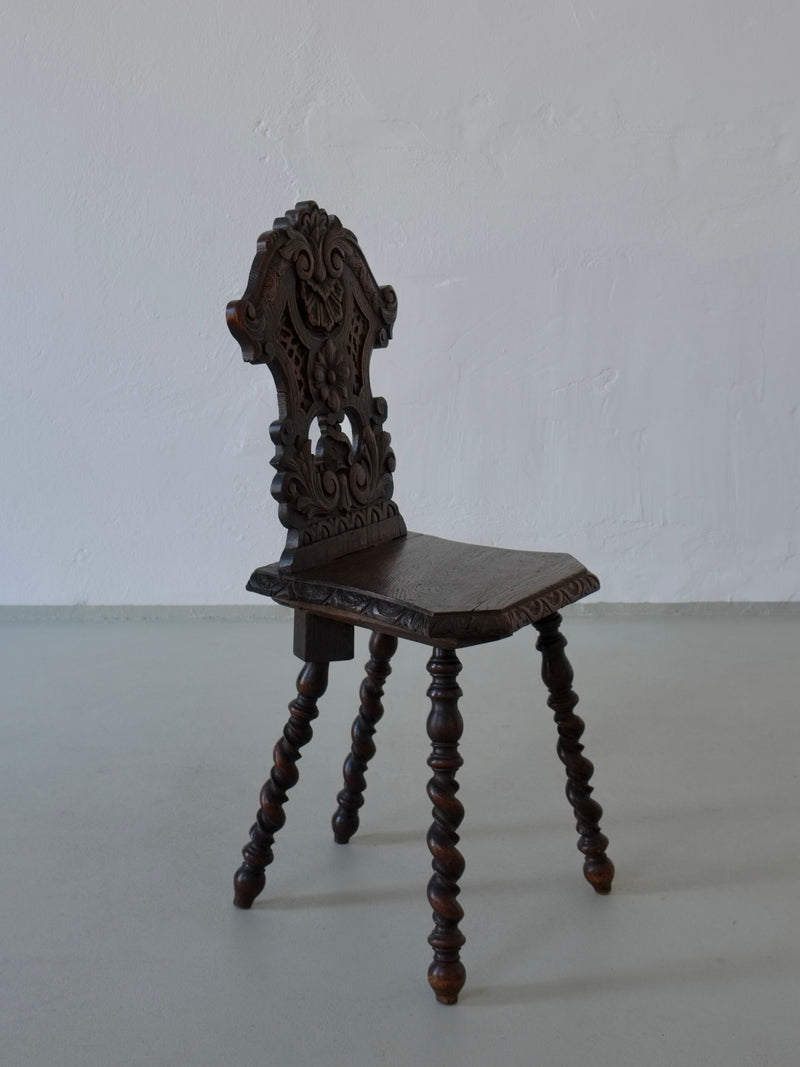 Ornate carved dark oak chair with twisted legs from 1900s