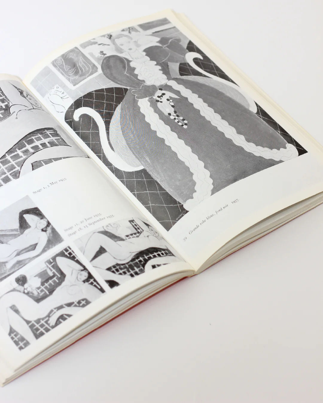 The Matisse on Art Book from Boga Avante Shop lies open, revealing black and white illustrations on a white surface. The pages feature abstract and geometric designs, influenced by Henri Matisse, with a larger image on the right and smaller ones thoughtfully arranged on the left.