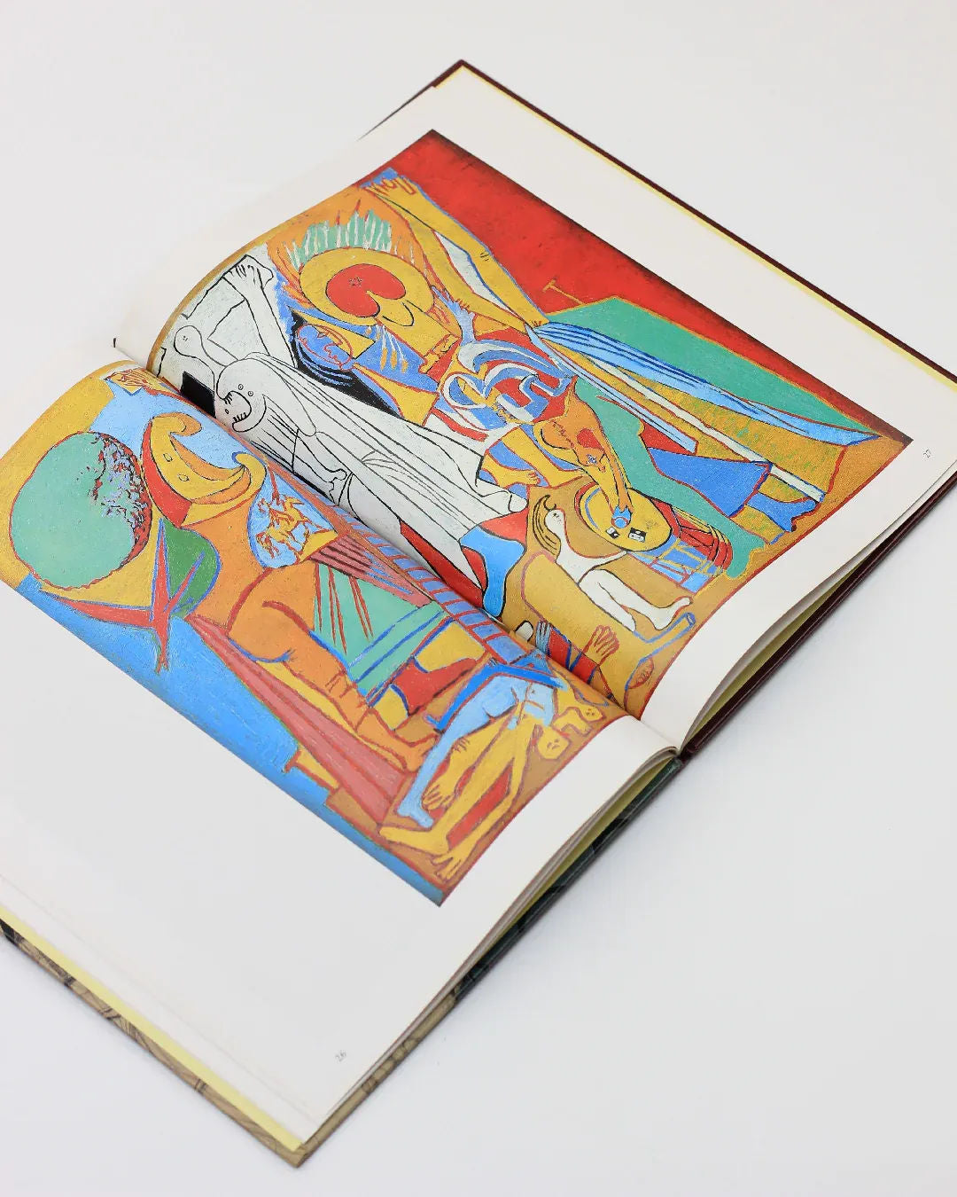 The *Picasso by Gabriel Potter Vintage Art Book* from *Boga Avante Shop* showcases colorful abstract artwork with bold shapes and vibrant hues, reminiscent of modern Spanish art, featuring figures and geometric patterns. It sits elegantly against a neutral background.