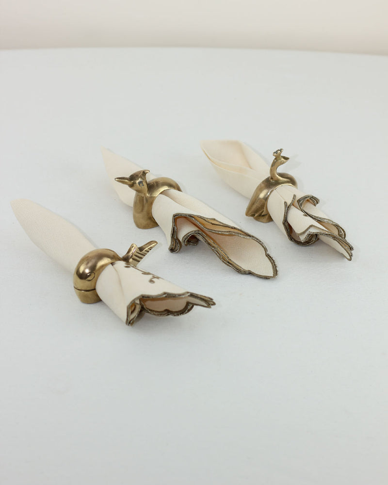 Set of three brass and bone animal napkin rings with handles