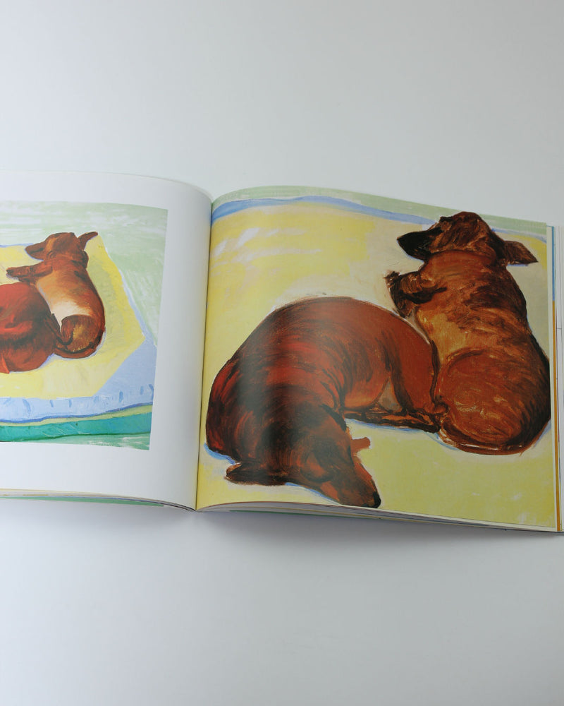 Open David Hockney Dog Days art book showing painted brown dogs