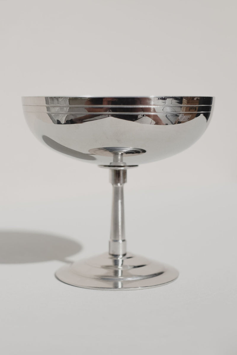 Polished steel ice coupe with reflective bowl and elegant stem
