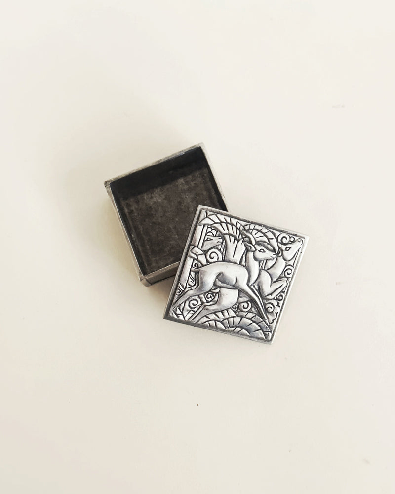 Art Deco pewter trinket box with ornate dolphin relief design