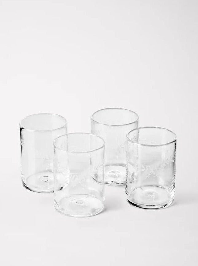 Four Akua Objects Barbro water glasses of varying sizes arranged neatly on a white background.