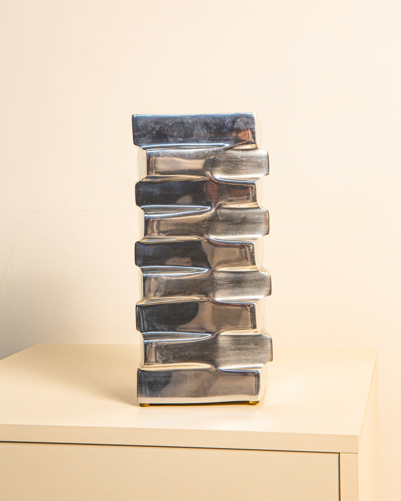 Stepped aluminum vase with metallic finish showing stacked design
