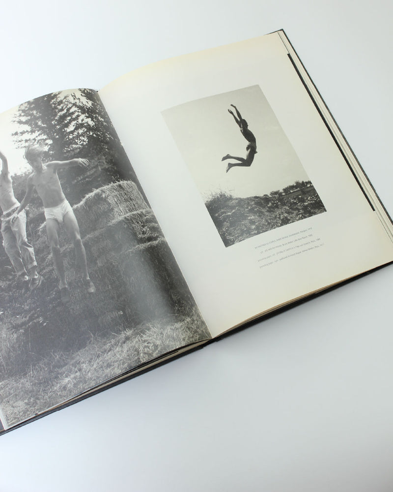 Open photography book showing black and white nature photographs