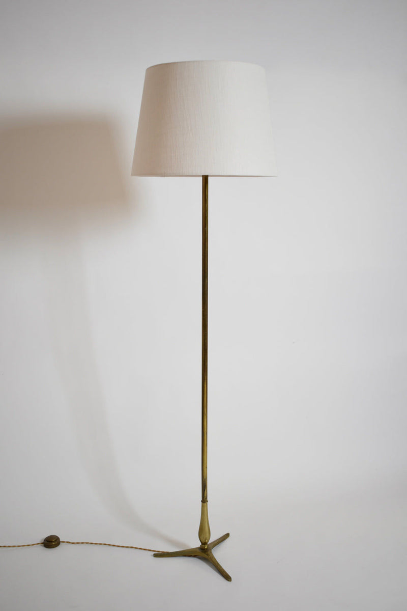The Tripod Baluster Neoclassical Floor Lamp (1960s) by Barracuda Interiors features a white fabric shade and three-legged brass base, standing elegantly against a white background with its cord visible, echoing Riccardo Scarpa style.