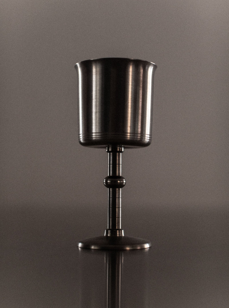 Set of four black and gold Art Deco style ceramic cups with intricate geometric patterns