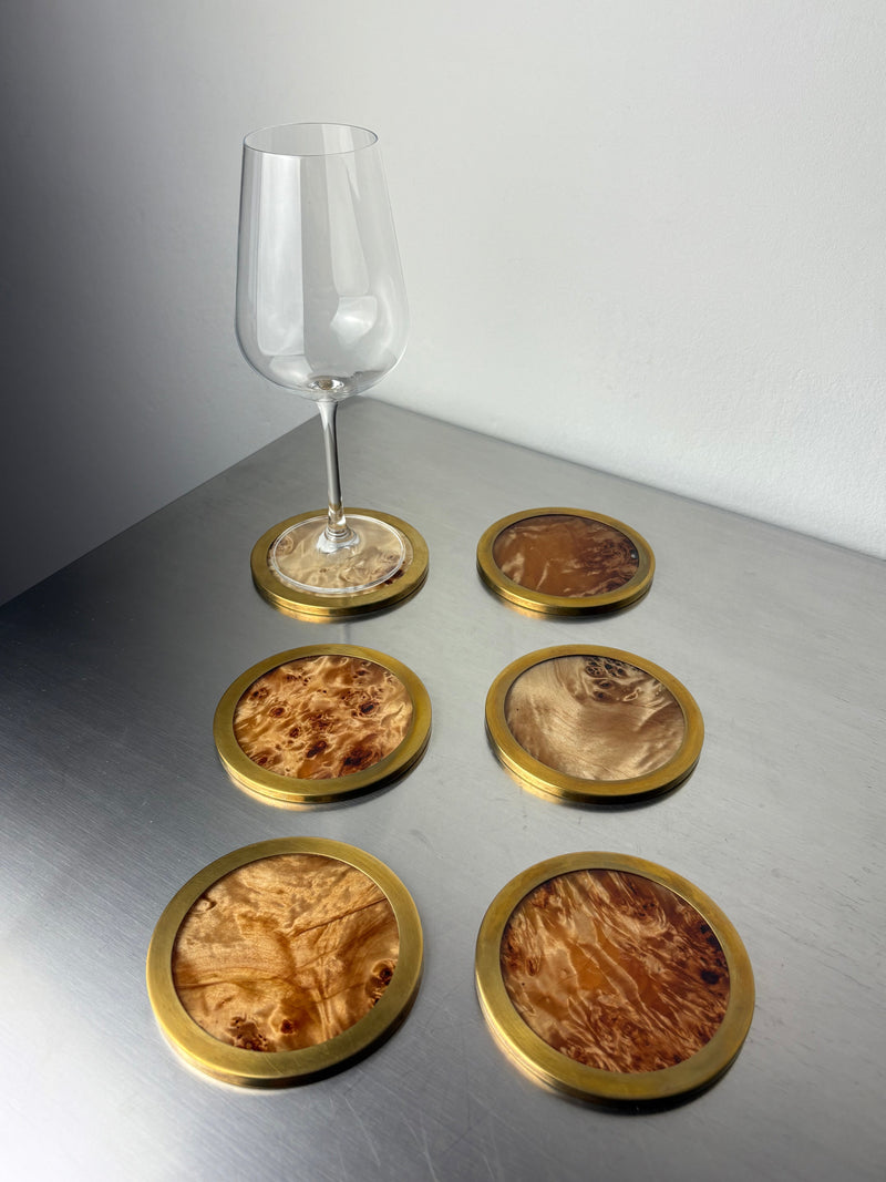 Set of six brass-rimmed burl wood coasters with wine glass, 1970s