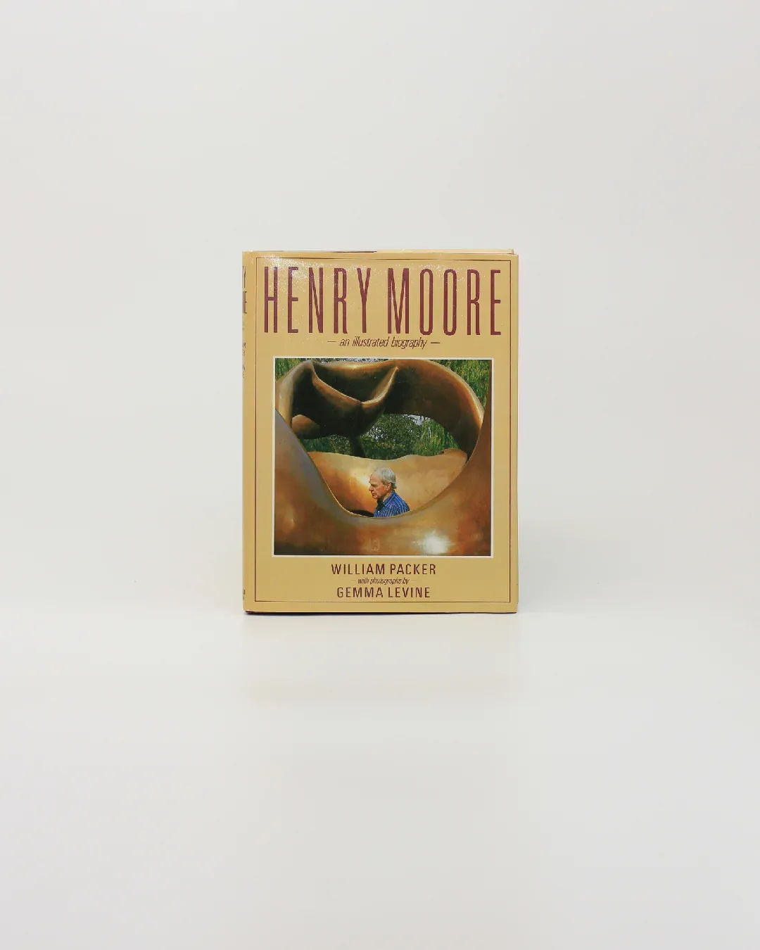 Henry Moore, An Illustrated Biography" from Boga Avante Shop is a vintage book spotlighting modern sculpture. The cover depicts a sculpture with someone seated inside it, against a grassy landscape on a simple white background.