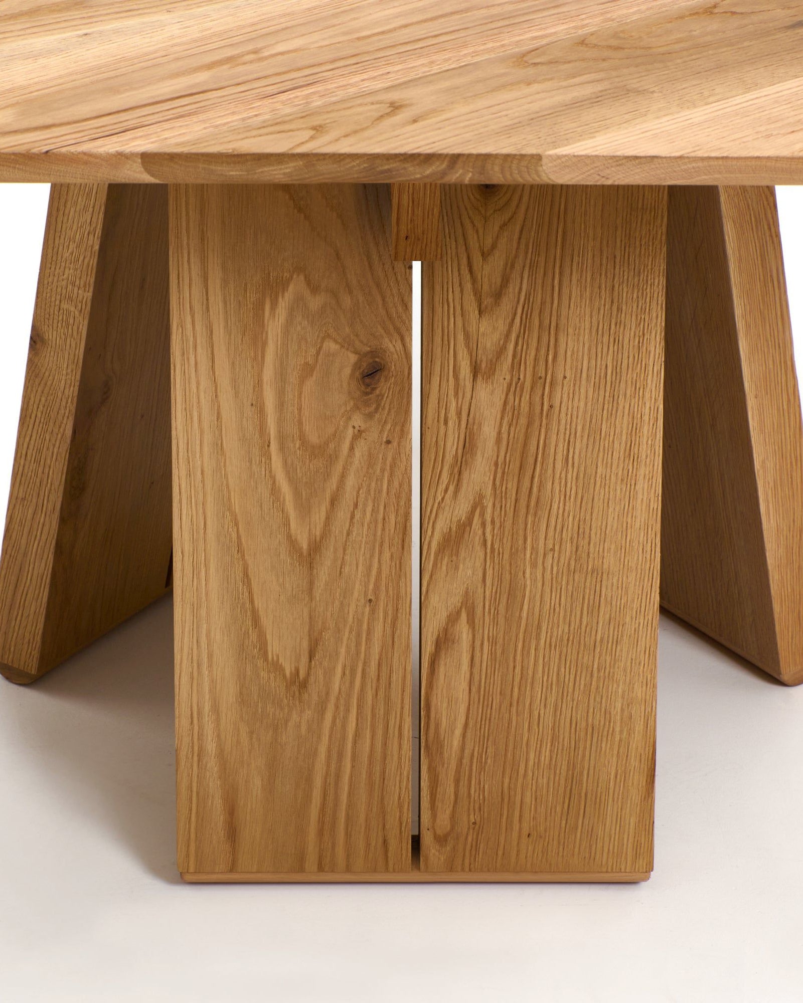 Oak dining table base detail showing angled leg construction
