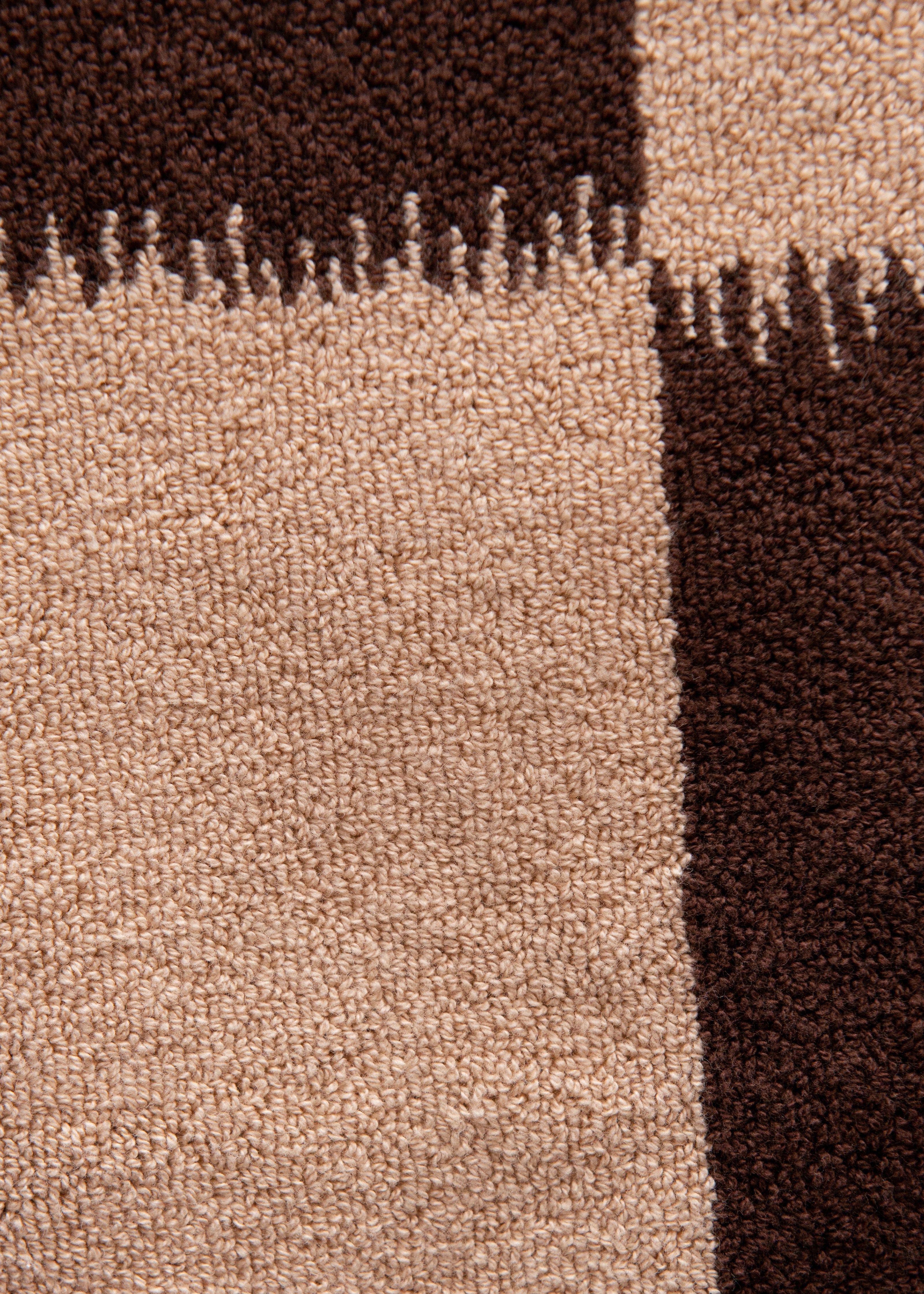 Close-up of an Autumn Sonata Karin Bath Mat showing a pattern with varying shades of brown, featuring detailed stitching and a soft, plush surface.