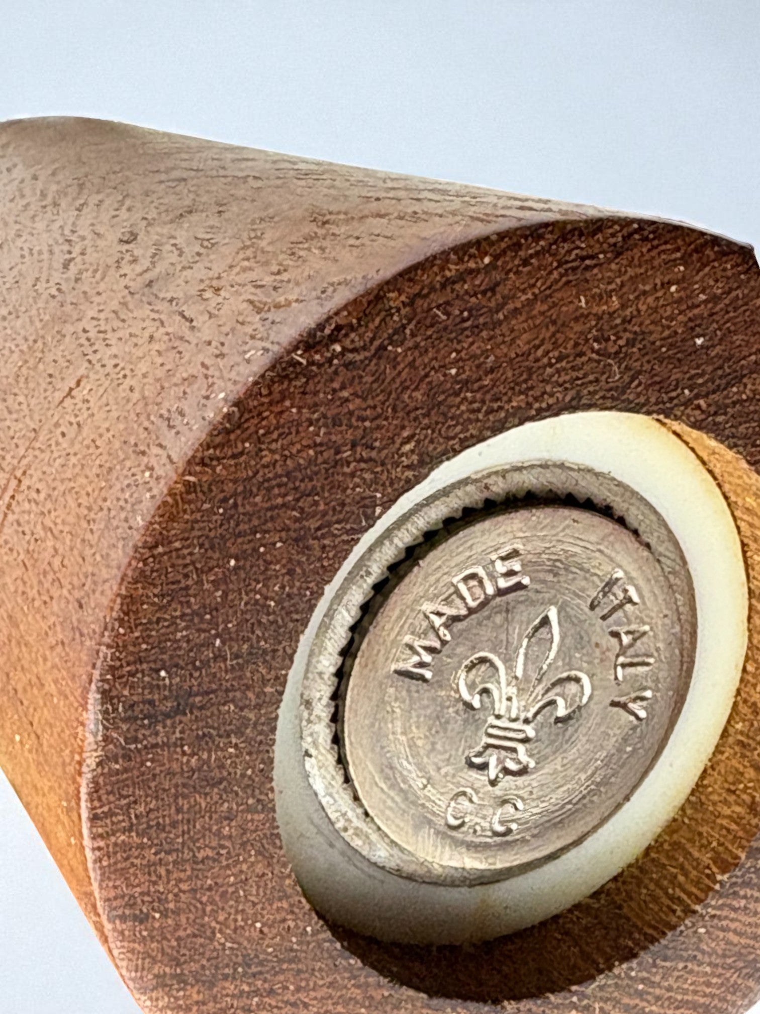 Close-up of rosewood salt shaker base showing brass maker's mark