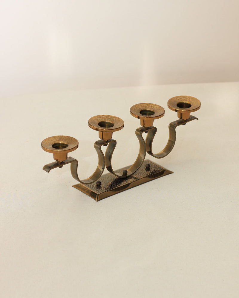Mid-century brass candelabra with curved arms on wooden base