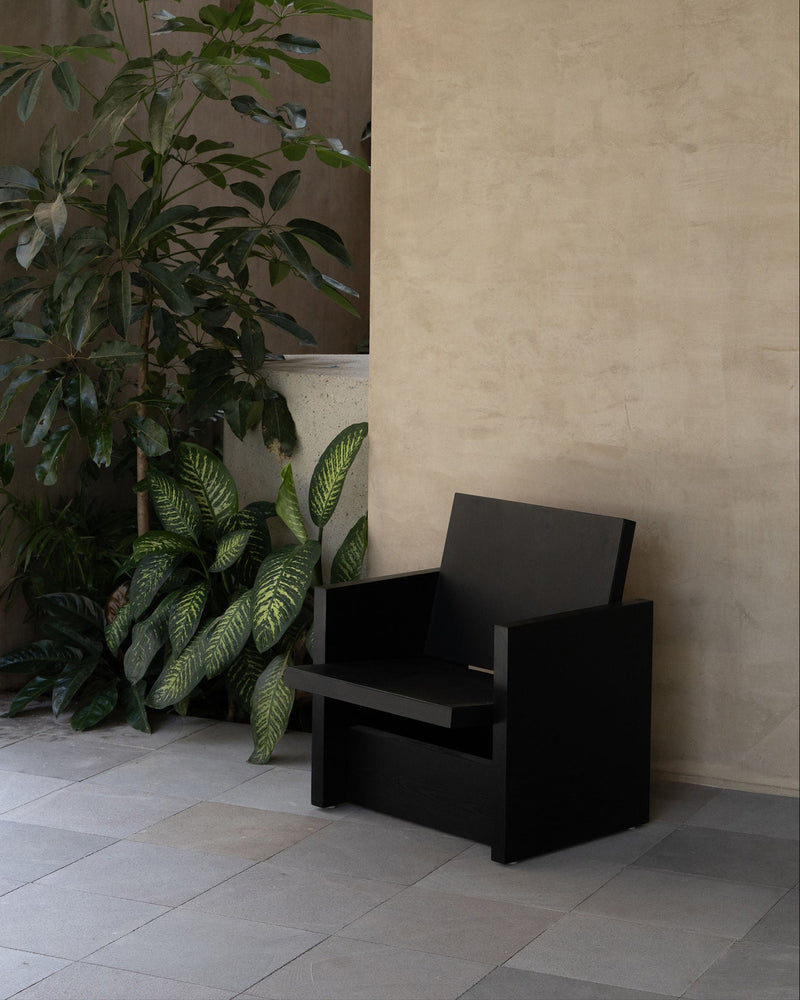 Clavijero black oak lounge chair in modern interior setting