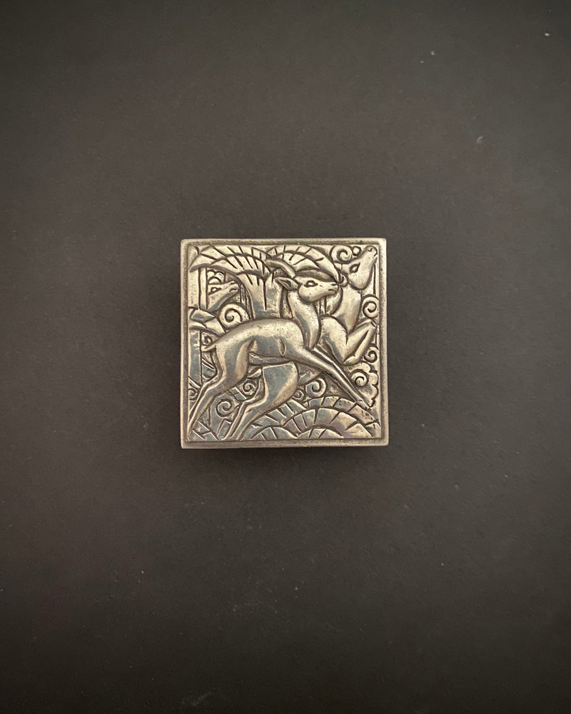 Art Deco pewter trinket box with embossed deer and sun motif