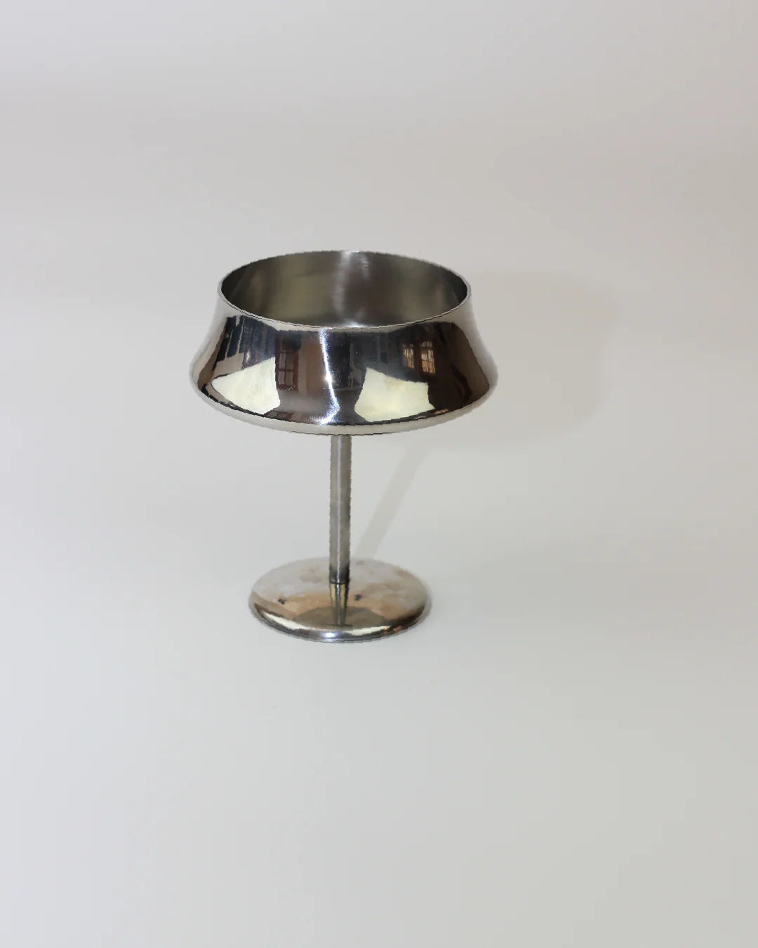 The Boga Avante Shop Set of Six Stainless Steel Cups features small, shiny cups with wide rims on tall stems and round bases, ideal for serving desserts or fruits. They resemble goblets and are shown against a plain white background.