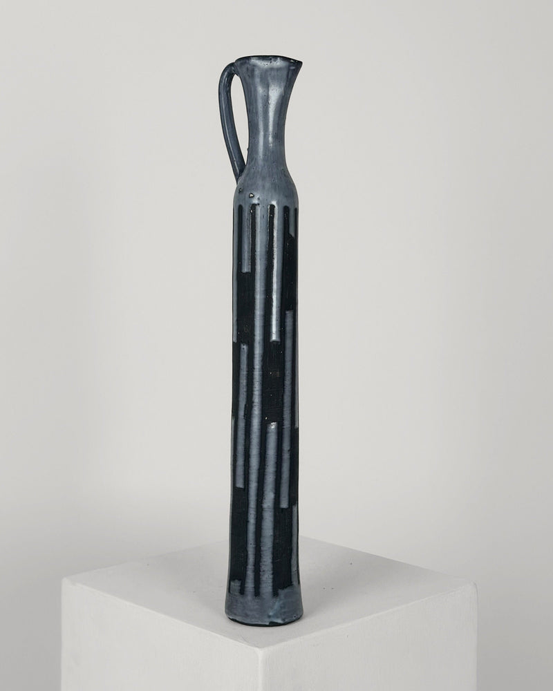 Dark blue ceramic bottle with vertical cutout pattern by Jacques Pouchain