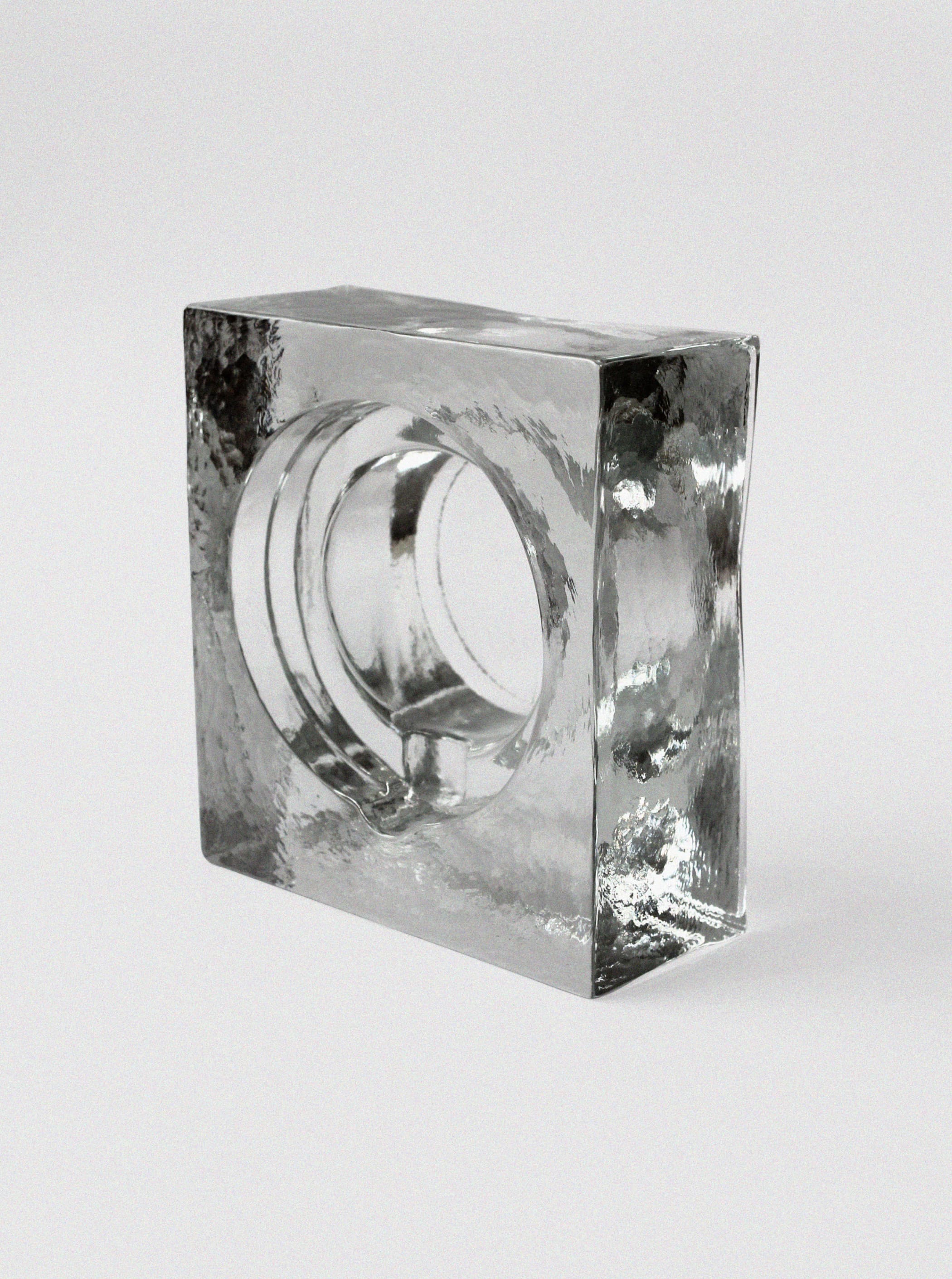 Massive ice glass ashtray showing sculptural hollow center detail