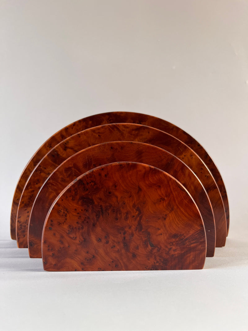 The Art Deco Burr Walnut Letter Holder by Maud Vaughan is a set of four semi-circular wooden pieces, resembling a desk organizer, arranged in a row with each slightly overlapping the next against a plain background. The wood exhibits a rich, reddish-brown color and showcases an exquisite burr veneer with its natural grain pattern beautifully visible.
