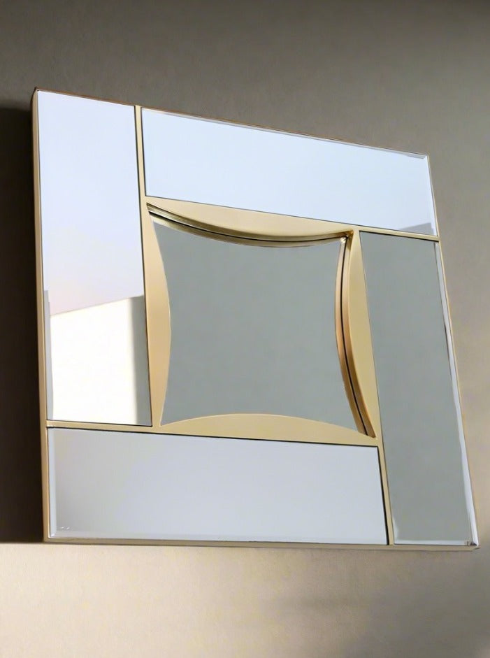 A modern, wall-mounted decorative mirror with an abstract design, the Mirror Belgo Chrome in Beveled Glass and Brass by LA NOUVELLE GALERIE features reflective, fragmented panels in varying geometric shapes. A distorted square mirror at the center and cloisonné glass accents along some edges add a striking visual effect as a sophisticated decorative element.