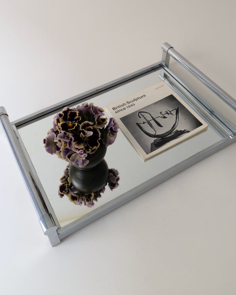 Adnet mirror styled with purple pansies on mirrored tray