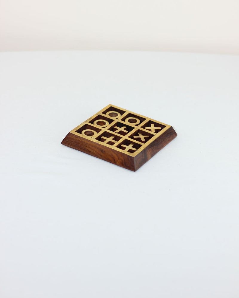 Wooden tic tac toe game with brass inlaid grid on walnut base