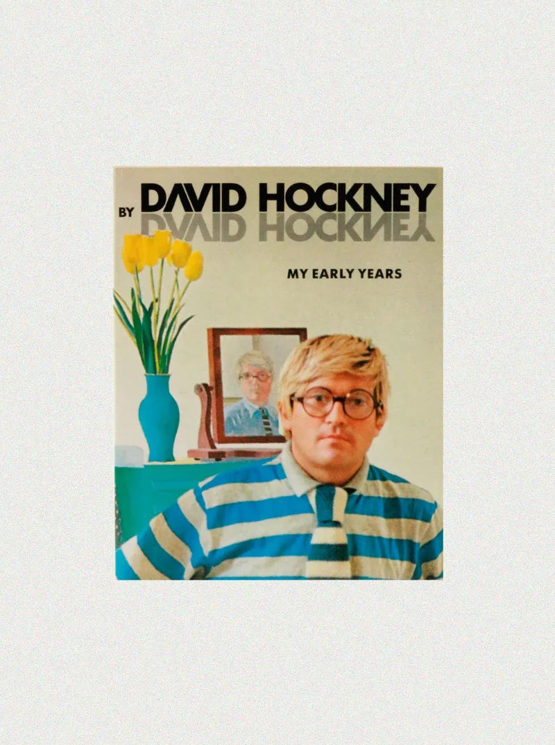 A book cover featuring David Hockney 'My Early Years.' The arte británico-inspired cover shows a man with light hair and glasses wearing a blue and white striped shirt with a white collar and bow tie. Behind him is a portrait of the same man, a vase with yellow flowers, and the book title. Available at Boga Avante Shop.